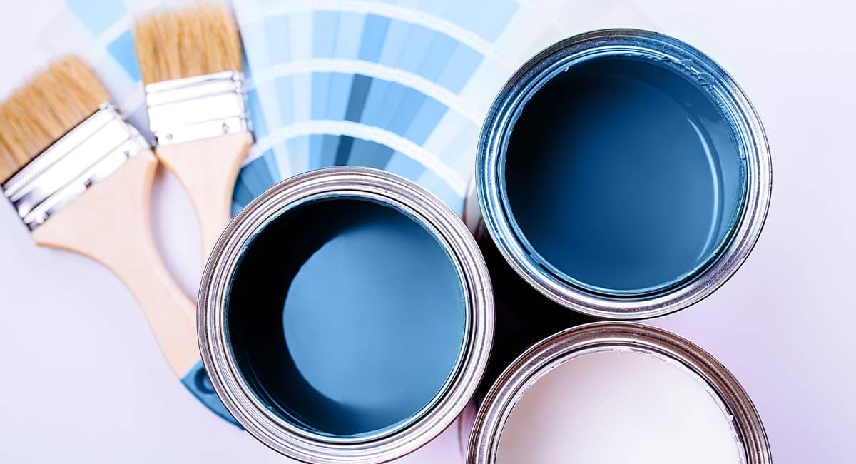 Nuancier bleu avec pots de peinture ouverts et pinceaux